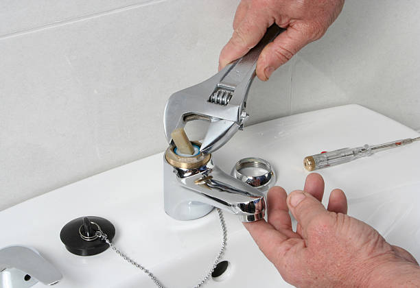 Plumber repairing the faucet of a sink